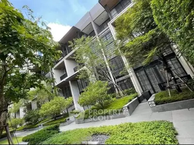 Modern apartment building with lush greenery and contemporary design