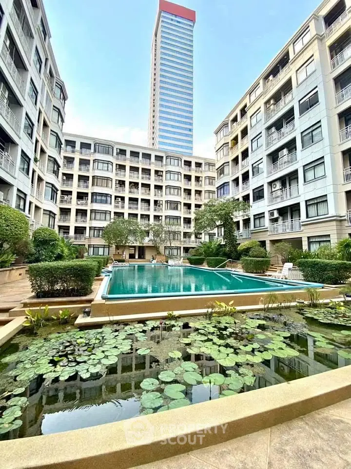 Luxurious residential complex with pool and garden, offering serene living in a modern urban setting.