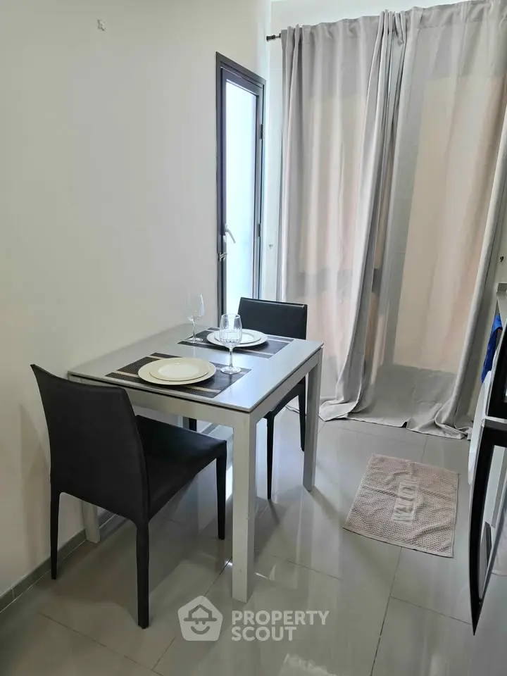 Cozy dining area with modern table and chairs, perfect for intimate meals in a stylish apartment.
