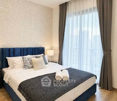 Luxurious bedroom with elegant decor and city view, featuring a plush bed and floor-to-ceiling windows.
