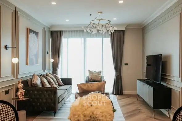 Elegant living room with modern decor and large windows, featuring stylish furniture and a chic chandelier.