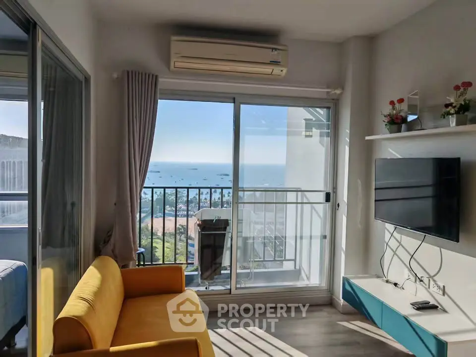 Bright living room with ocean view, modern decor, and vibrant yellow sofa.