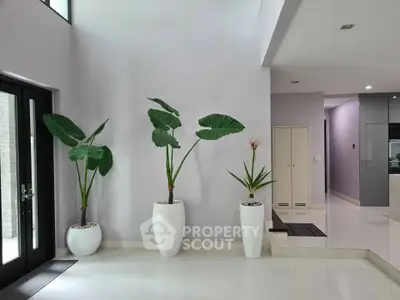 Elegant modern interior with large potted plants and sleek design