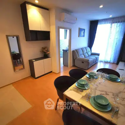 Modern living room with dining area, stylish furniture, and natural light.