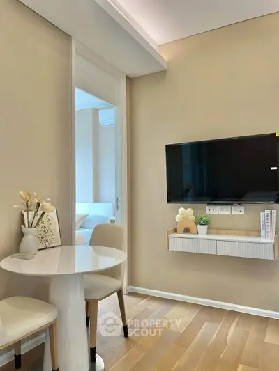 Modern living room with wall-mounted TV and elegant dining area