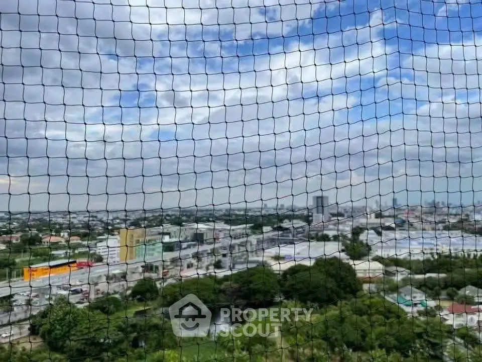 Stunning cityscape view from high-rise building with expansive skyline and lush greenery.