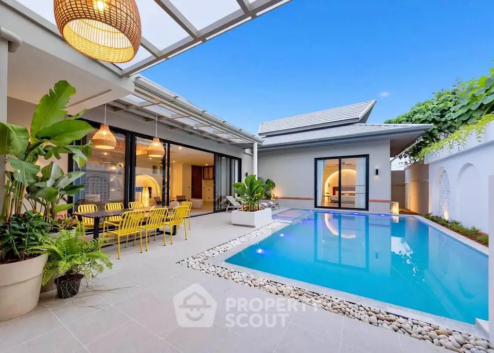 Luxurious modern home with stunning pool and outdoor dining area, perfect for entertaining.