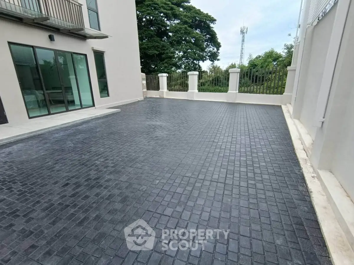 Spacious outdoor parking area with modern paving in a residential complex.