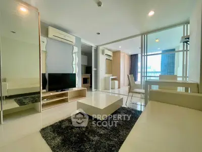 Modern living room with sleek furniture and large windows in a stylish apartment.
