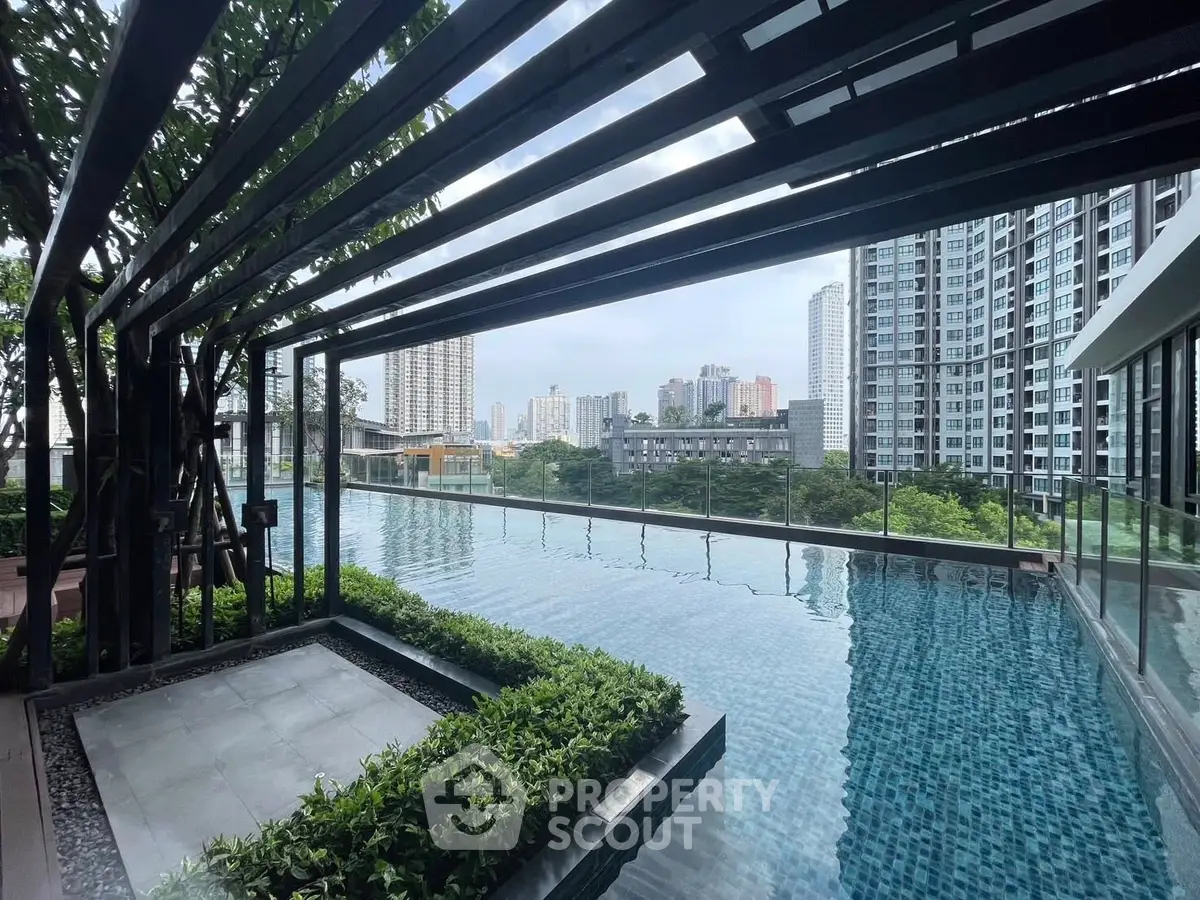 Luxurious rooftop pool with stunning city skyline views in modern high-rise building.