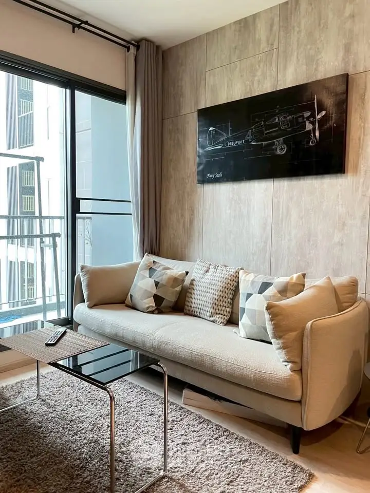 Modern living room with stylish decor and balcony view