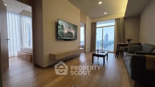 Spacious modern living room with city view, wooden flooring, and elegant decor