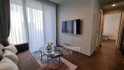 Modern living room with sleek TV setup and elegant decor in a stylish apartment.