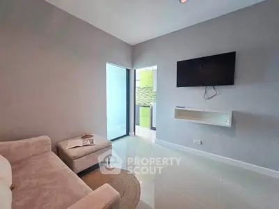 Modern living room with sleek TV setup and cozy seating area