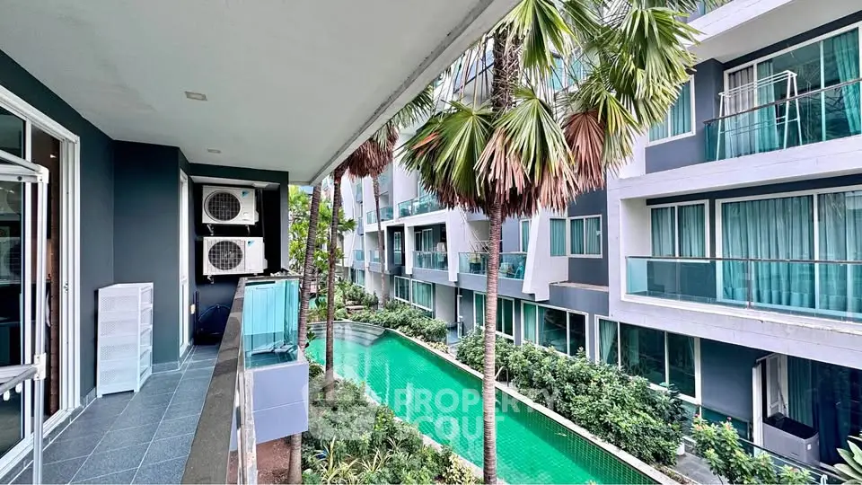 Modern apartment complex with pool view and lush greenery