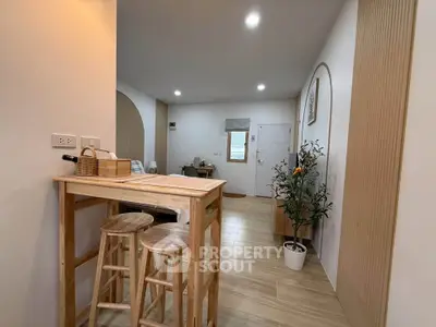 Modern open-plan living area with wooden accents and stylish decor