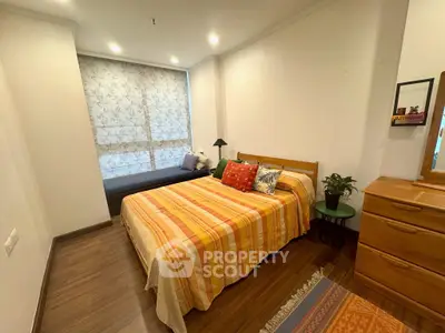 Cozy bedroom with stylish decor and natural light