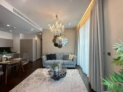 Luxurious living room with elegant chandelier and plush decor in modern apartment