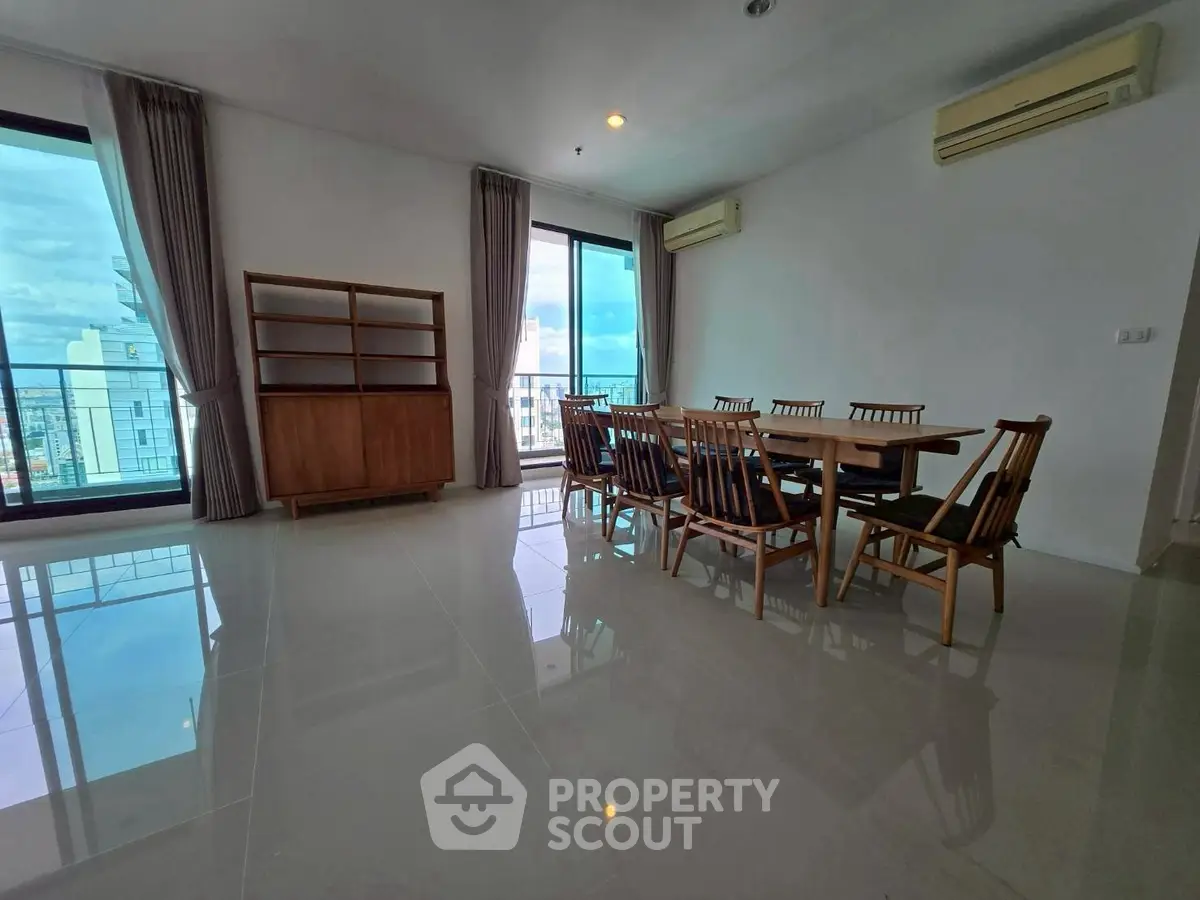 Spacious dining area with city view and elegant wooden furniture