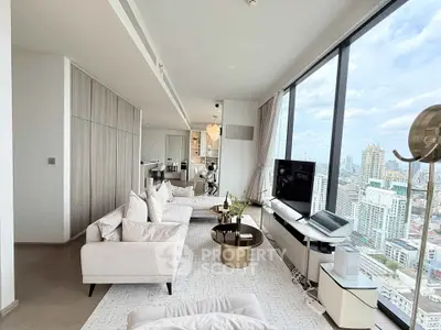 Luxurious high-rise living room with panoramic city views and modern decor.