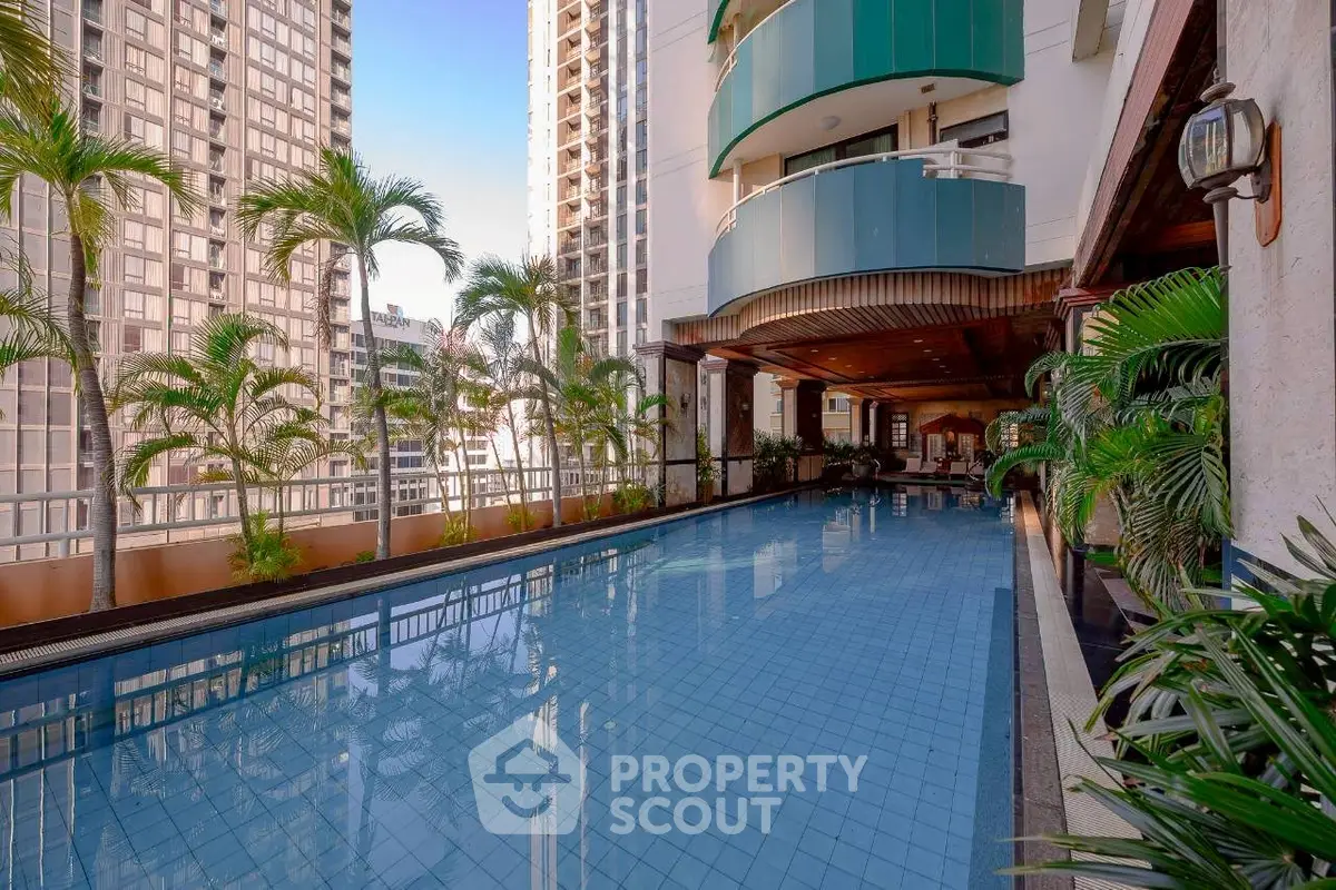 Luxurious high-rise building with stunning pool and lush greenery, perfect for urban living.