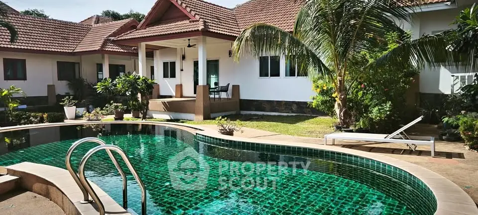 Luxurious villa with private pool and lush garden, perfect for tropical living.