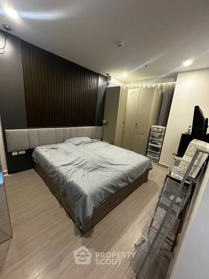 Modern bedroom with stylish decor and ample storage in a contemporary apartment.