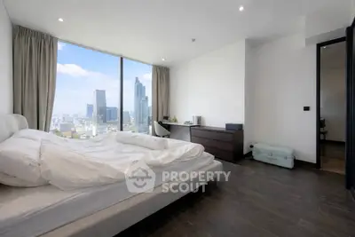 Luxurious bedroom with stunning city view in modern high-rise apartment