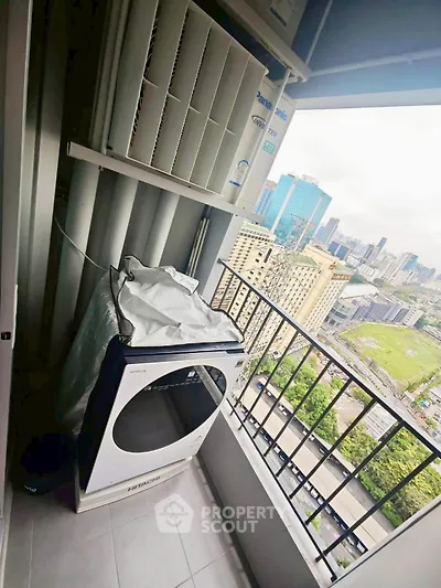 High-rise balcony with city view and laundry appliances, perfect for urban living.