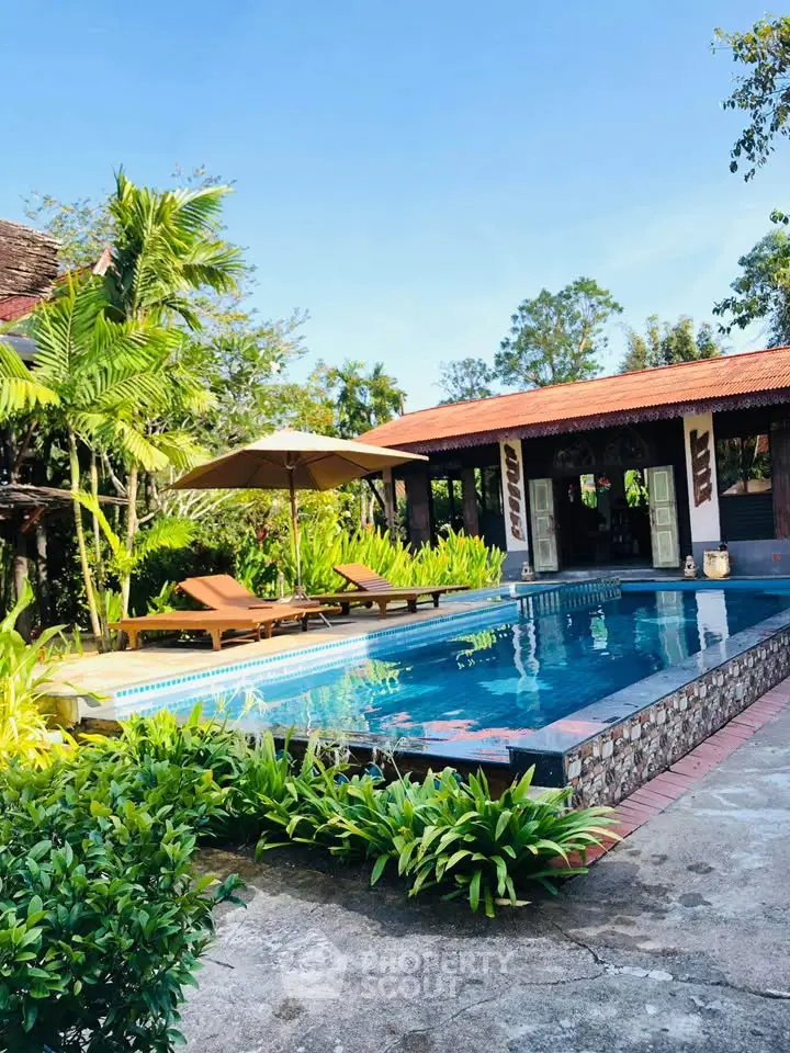 Luxurious tropical villa with private pool and lush garden, perfect for relaxation and leisure.