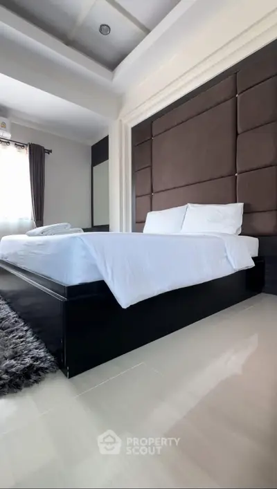 Luxurious bedroom with modern design and plush bedding in a stylish real estate property.