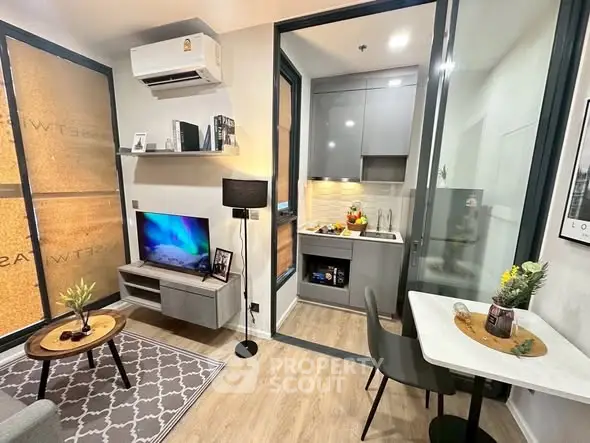 Modern compact living room with open kitchen, stylish decor, and cozy dining area in a chic apartment.