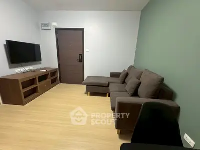 Modern living room with sleek furniture and wall-mounted TV, perfect for cozy relaxation.