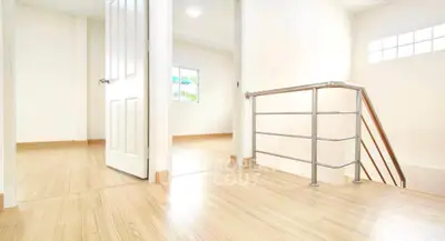 Bright and airy hallway with modern railing and wooden flooring