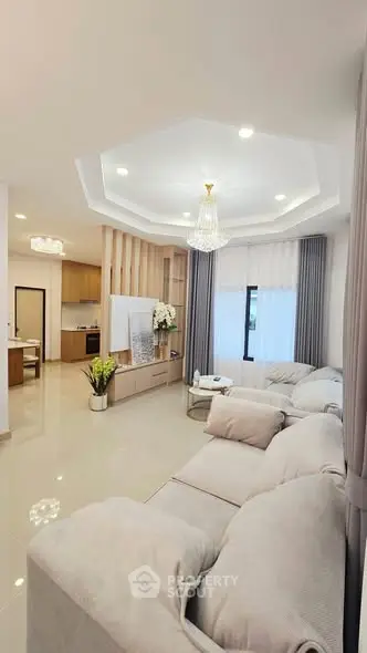 Luxurious living room with elegant chandelier and plush sofas in modern home