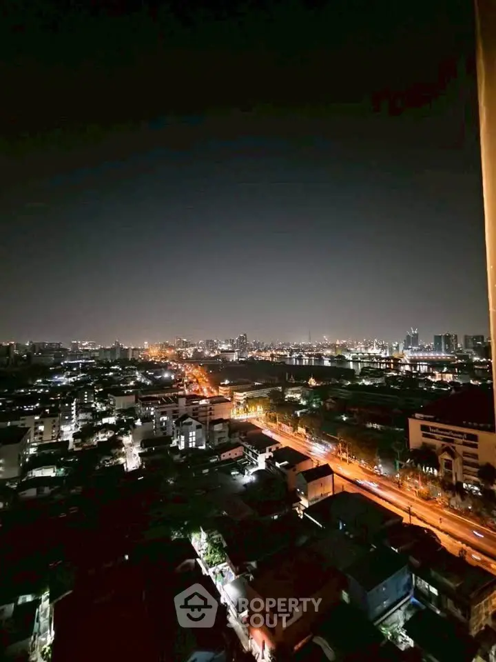 Stunning cityscape night view from high-rise apartment balcony.