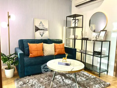 Stylish living room with modern decor, plush sofa, and elegant shelving