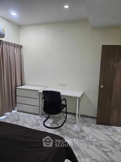 Modern bedroom with sleek furniture and marble flooring, perfect for a minimalist lifestyle.