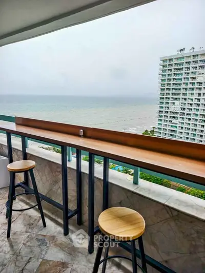 Stunning ocean view from a modern balcony with bar seating, perfect for relaxation and enjoying the scenery.