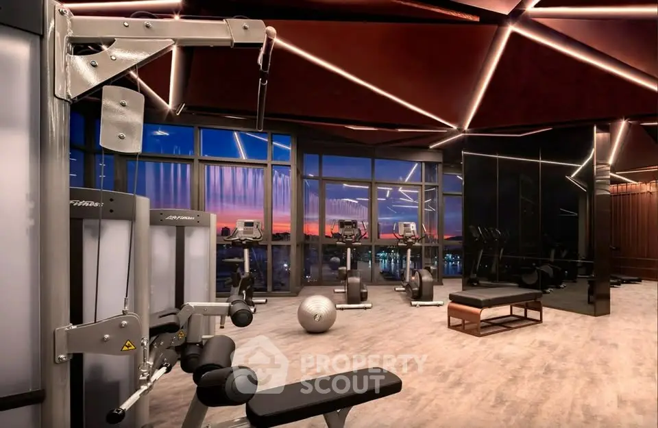 Luxurious high-rise gym with panoramic city views and modern fitness equipment.