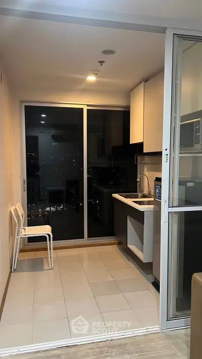Modern kitchen with sleek design and city view, featuring open layout and stylish cabinetry.