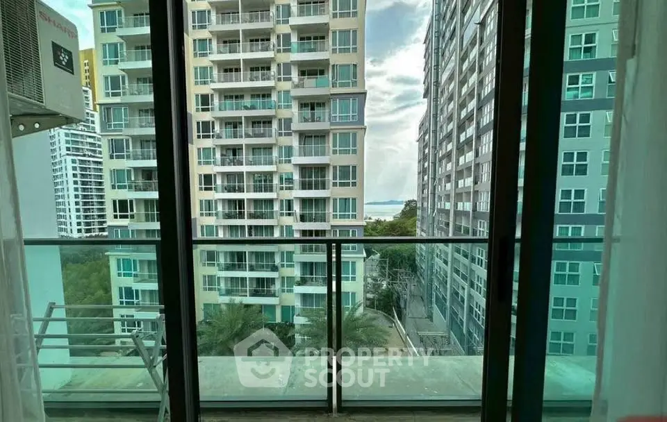 Stunning balcony view of modern high-rise buildings with a glimpse of the sea.