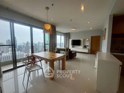 Spacious modern living room with city view and open layout dining area.
