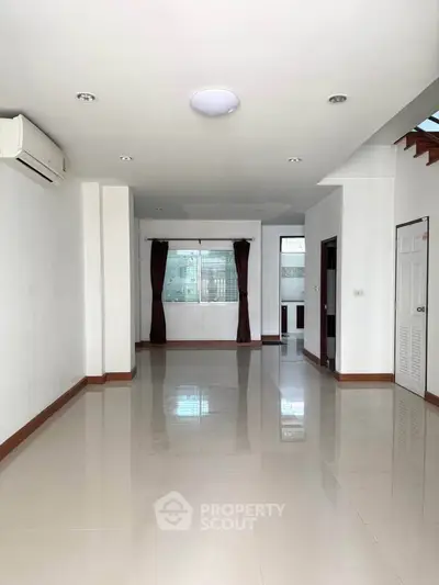 Spacious unfurnished living room with air conditioning and natural light