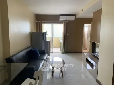 Spacious living room with modern furniture and natural light in a stylish apartment.