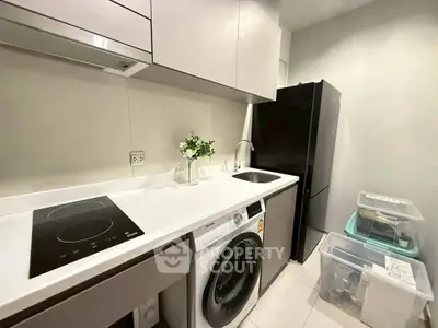 Modern kitchen with sleek appliances and ample storage space.