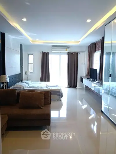 Spacious modern bedroom with sleek design and ample natural light