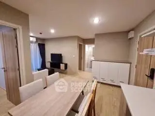 Modern open-plan living and dining area with stylish furniture and neutral tones.