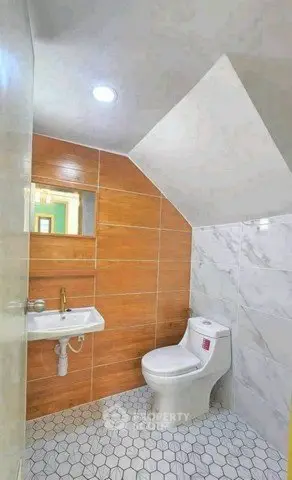 Modern bathroom with stylish tile design and compact layout