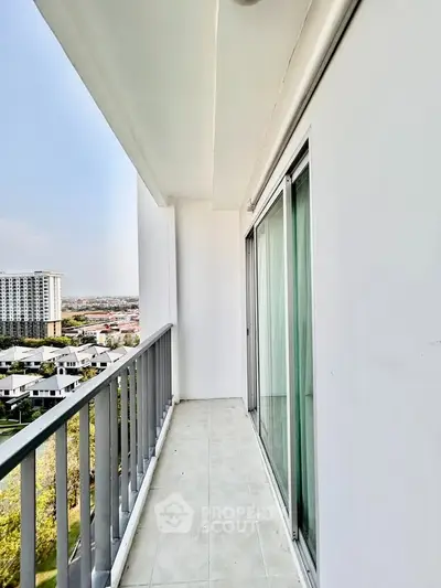 Spacious balcony with stunning city view in modern high-rise apartment